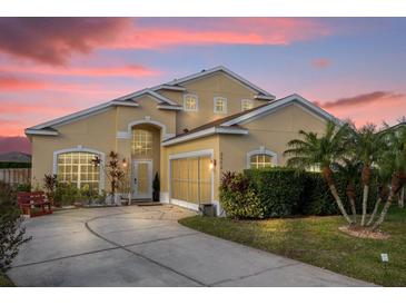 Two-story house with a beige exterior, landscaped yard, and a two-car garage at 2570 Amaya Ter, Lake Mary, FL 32746