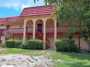 Two story apartment building with red tile roof and balconies at 2860 N Powers Dr # 14, Orlando, FL 32818