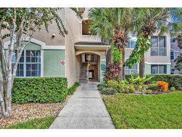 Attractive building exterior with landscaping and walkway at 4865 Cypress Woods Dr # 2204, Orlando, FL 32811
