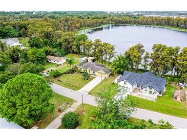 Aerial view of lakefront property with two houses at 16837 Arrowhead Blvd, Winter Garden, FL 34787