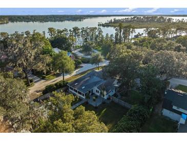Aerial view showcasing a charming house near the lake at 635 Butler St, Windermere, FL 34786