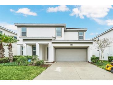 Two-story house with attached garage and landscaping at 320 Ballo Dr, Kissimmee, FL 34746