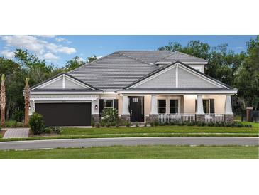A charming one-story house with gray siding and a dark brown garage door at 1400 Arklow Cir, Ormond Beach, FL 32174