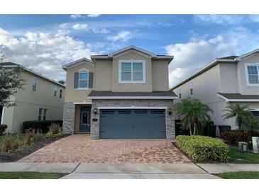 Two-story house with stone accents and a two-car garage at 7405 Marker Ave, Kissimmee, FL 34747