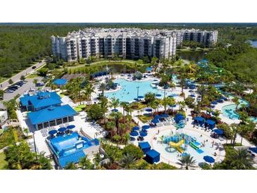 Aerial view of resort-style community with large pool and water features at 14501 Grove Resort Ave # 2740, Winter Garden, FL 34787