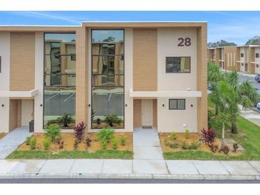 Modern two-story townhouse with large windows at 3062 Rockefeller Way, Kissimmee, FL 34747