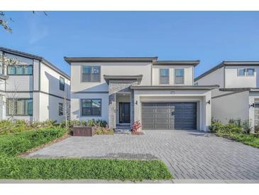 Modern two-story home with attached garage and landscaping at 6115 High Seas Dr, Orlando, FL 32821