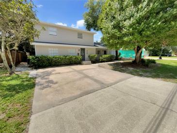 Two-story house with a large driveway and mature trees at 326 Banyan Dr, Maitland, FL 32751