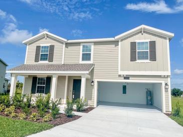 Two-story home with two-car garage and landscaping at 4499 Magnolia Ridge Ct, Kissimmee, FL 34746