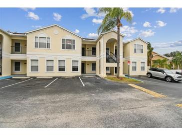 Two-story condo building with parking and landscaping at 8827 Grand Palms Cir # B, Kissimmee, FL 34747