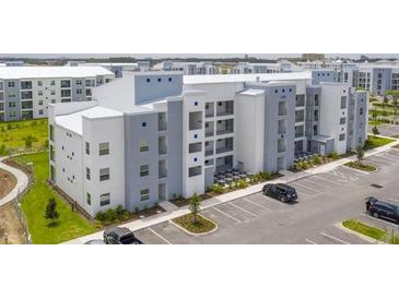 Modern apartment building with ample parking and landscaping at 3180 Paradox Circle # 203, Kissimmee, FL 34746