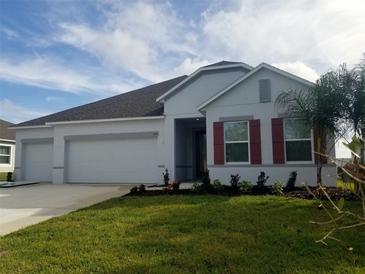 Newly built home with a three-car garage and red shutters at 204 Barrington Dr, Haines City, FL 33844