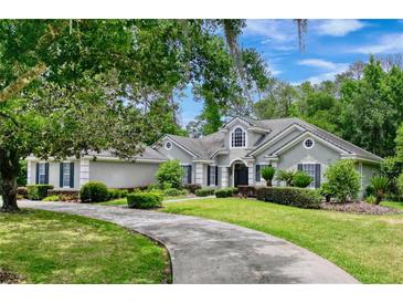 Two-story home with a circular driveway and landscaping at 310 Vista Oak Dr, Longwood, FL 32779