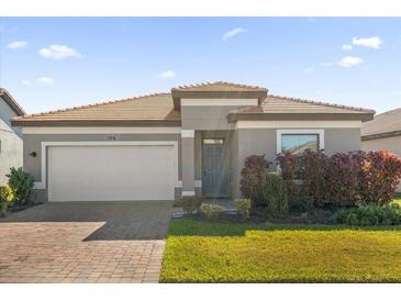 Single-story home with gray exterior, tile roof, and a two-car garage at 196 Aidans Lndg, Haines City, FL 33844