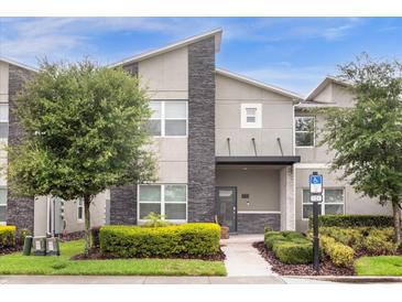 Modern two-story townhome with stone accents at 770 Pebble Beach Dr, Davenport, FL 33896
