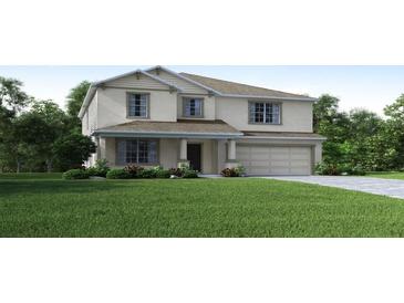 Two story house with a two car garage and manicured lawn at 2223 Elegant Manor Cir, Edgewater, FL 32141