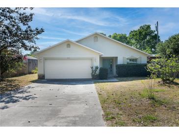 One-story house with attached garage and landscaped front yard at 221 Rosa Ave, Oviedo, FL 32765