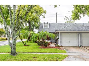 Gray house with a two car garage and nicely manicured lawn at 4548 Summergrove Ave, Orlando, FL 32812