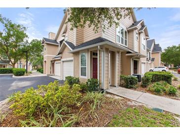 Two-story townhome with attached garage and nicely landscaped front yard at 2045 Erving Cir # 101, Ocoee, FL 34761