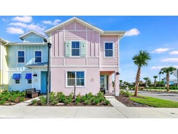 Pastel-colored townhome with landscaping and sidewalk at 8103 Coconut Place, Kissimmee, FL 34747