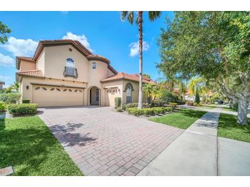 Two-story home with a tile roof, large driveway and landscaping at 11514 Via Lucerna Cir, Windermere, FL 34786