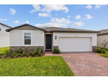 One-story house with two-car garage and brick driveway at 1167 Foreshore Ln, Haines City, FL 33844
