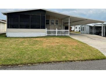 Single-wide manufactured home with carport and fenced yard at 1785 Quail Hill Dr, Lakeland, FL 33810
