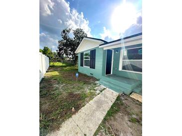 Newly painted teal home with walkway at 2015 1/2 Laurel St, Bartow, FL 33830