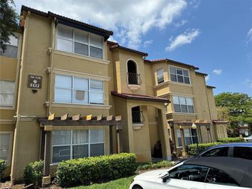 Condo building exterior featuring attractive architectural details and landscaping at 5132 Conroy Rd # 937, Orlando, FL 32811