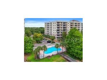 Community pool with surrounding landscaping at 6312 Buford St # 303, Orlando, FL 32835