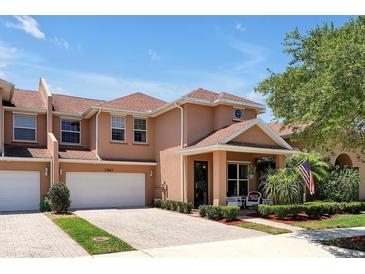 Two-story townhome with two-car garage and front porch at 3587 Casalta Cir, New Smyrna Beach, FL 32168