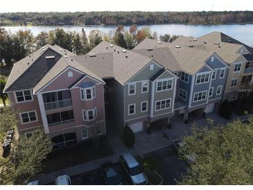 Aerial photo of condo building near lake at 3446 Soho St # 304, Orlando, FL 32835