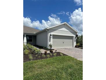 House exterior featuring a two-car garage and landscaped yard at 2590 Cliff Way, Saint Cloud, FL 34771