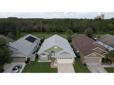 Three homes, two-story, two car garage. View of neighborhood at 3128 Crystal Creek Blvd, Orlando, FL 32837