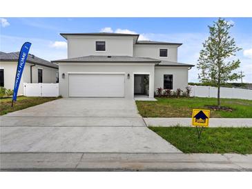 Two-story house with attached garage and modern facade at 6422 Chorus Dr, Mascotte, FL 34753
