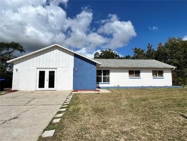 House exterior featuring a two-toned paint scheme and double doors at 7313 Cabor Ct, Orlando, FL 32818