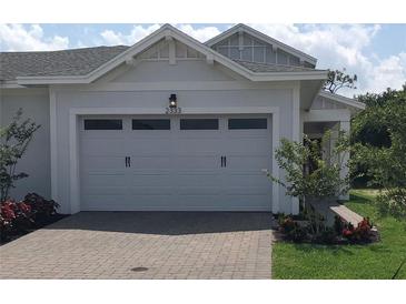 Two-car garage with a brick paved driveway at 2333 Datura Loop, St Cloud, FL 34772