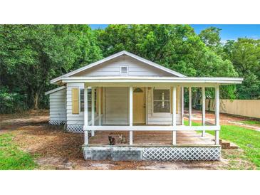 Charming single-story house with a front porch and small yard at 5136 Mcdonald Rd, Zellwood, FL 32798