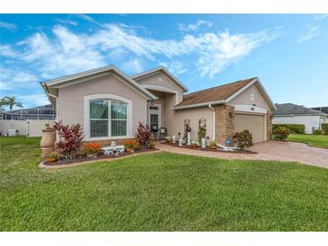 House exterior showcasing a two-car garage and well-maintained landscaping at 442 Ella Mae Dr, Davenport, FL 33897
