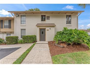 Exterior of condo building with manicured landscaping and walkway at 200 Maitland Ave # 20, Altamonte Springs, FL 32701