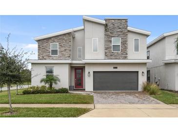 Two-story modern home with stone accents and two-car garage at 8834 Cabot Cliffs Dr, Davenport, FL 33896
