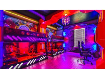 Themed bedroom with bunk beds and vibrant lighting at 3020 Mahalo Dr, Davenport, FL 33897