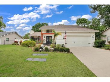 Charming two-story home with landscaped yard and attached two-car garage at 603 Antilla Ave, Altamonte Springs, FL 32714