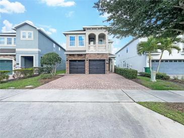 Two-story house with a two-car garage and well-manicured lawn at 7574 Marker Ave, Kissimmee, FL 34747