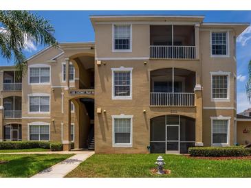 Condo building exterior with multiple units and landscaping at 8101 Coconut Palm Way # 203, Kissimmee, FL 34747