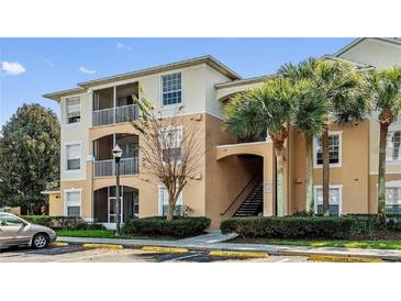 Condo building with palm trees and parking at 6214 Stevenson Dr # 201, Orlando, FL 32835
