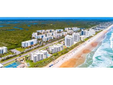 Aerial view of community, showcasing beach access and lush landscaping at 5300 S Atlantic Ave # 15-403, New Smyrna Beach, FL 32169