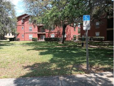 Exterior view of building showing landscaping and parking at 1325 Rotonda Pt # 125, Lake Mary, FL 32746