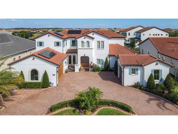 Two-story home with tile roof, solar panels and brick driveway at 15680 Panther Lake Dr, Winter Garden, FL 34787
