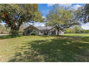 Single story home with large yard and mature trees at 2017 W State Road 426, Oviedo, FL 32765